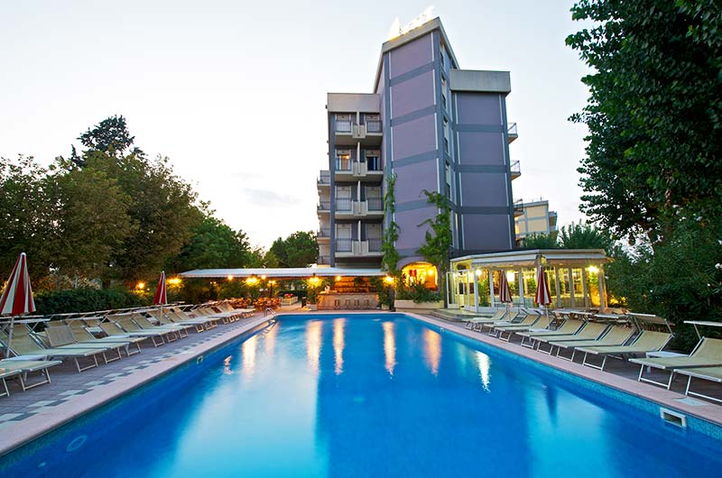 The pool and the hotel at sunset