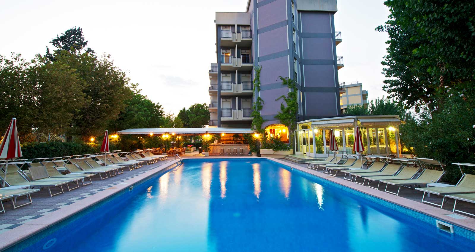 The pool and the hotel at sunset